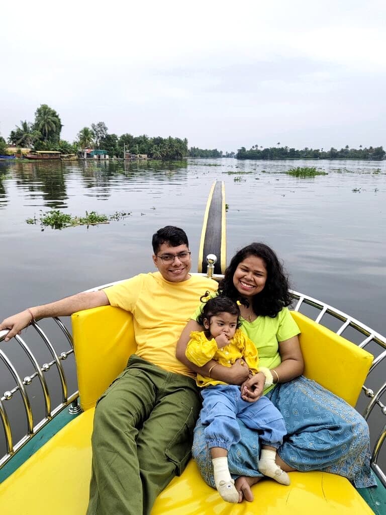 Family with a young child enjoying the cushioned front deck of a private shikara boat on Alappuzha backwaters