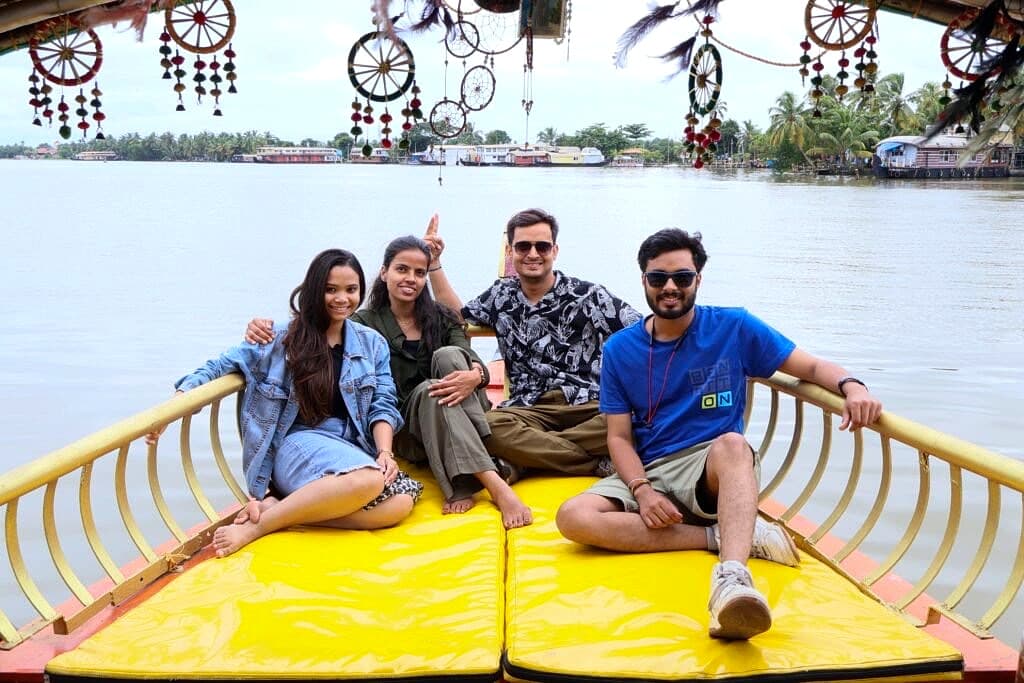 Group of friends enjoying a private shikara boat cruise through scenic Alleppey backwater waterways